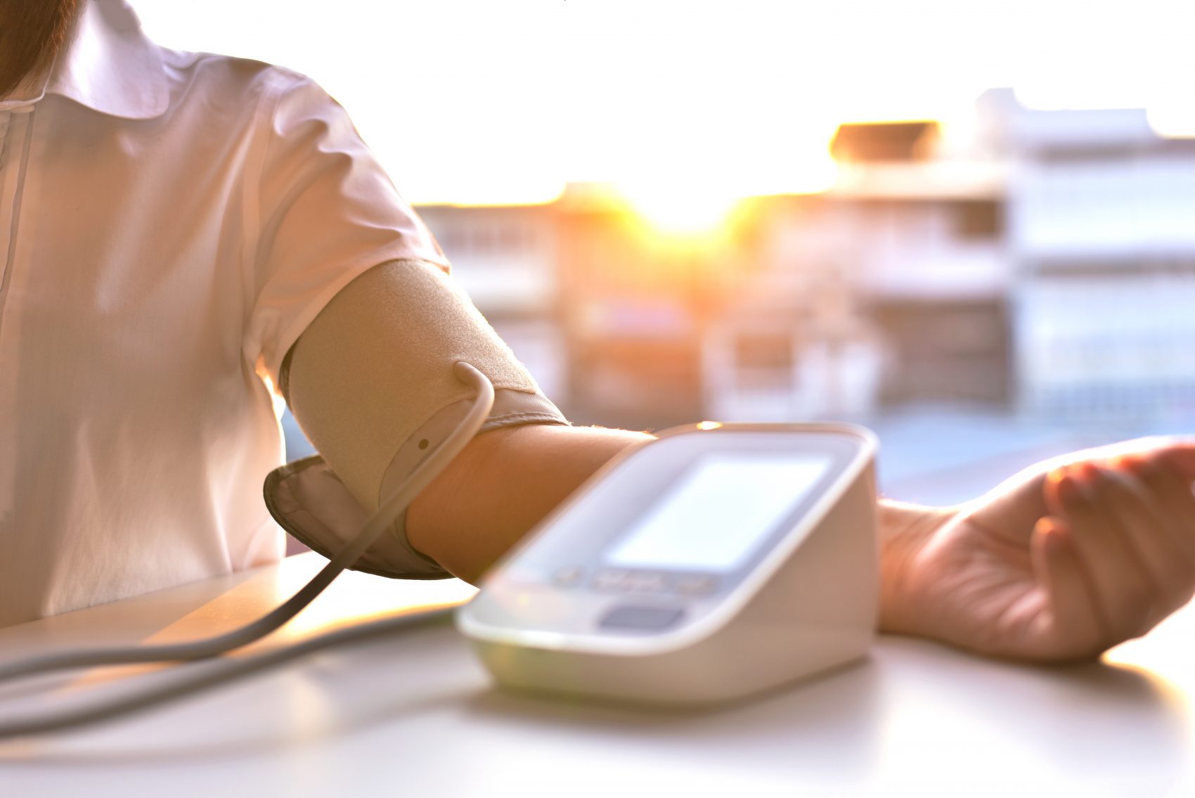 A man getting his blood pressure checked, talk to a Crown Point dentist today.